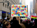 Naisten mielenosoitus Yhdysvalloissa tammikuussa 2017, kyltti "This is what Democracy looks like"